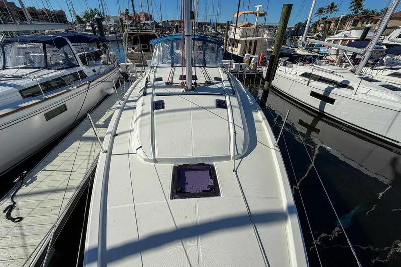 Slide: The Image of 2022 Beneteau Oceanis 40.1 sailboat docked at marina, surrounded by other boats. - 102