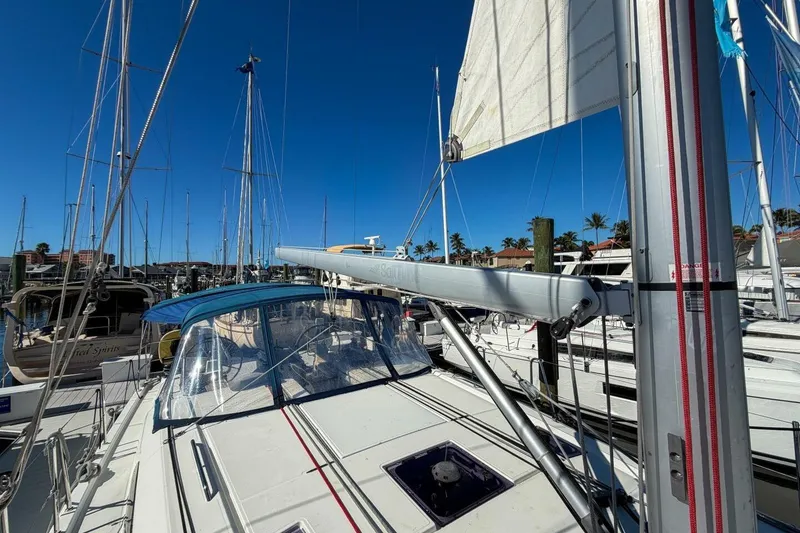 Slide: The Image of 2022 Beneteau Oceanis 40.1 sailboat docked in marina under clear blue sky. - 103