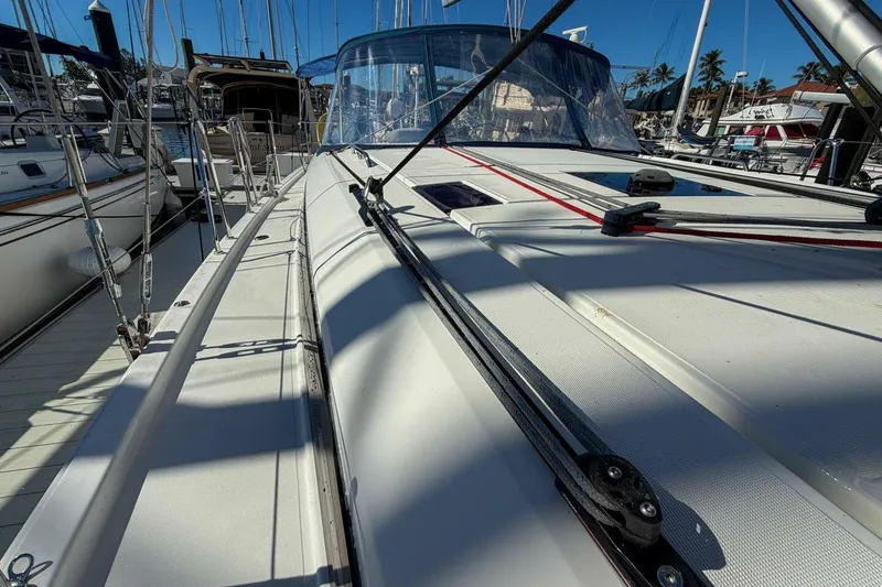 Slide: The Image of 2022 Beneteau Oceanis 40.1 sailboat deck view in marina, showcasing sleek design and rigging. - 104