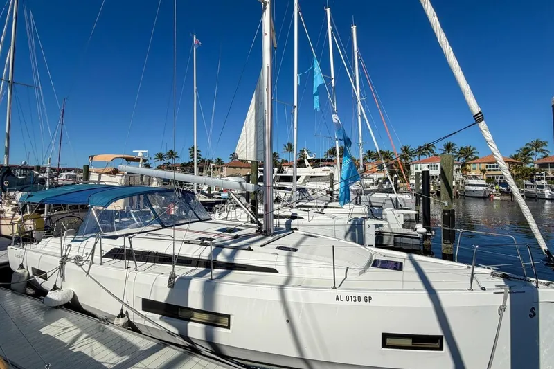 Slide: The Image of 2022 Beneteau Oceanis 40.1 sailboat docked in a sunny marina. - 108