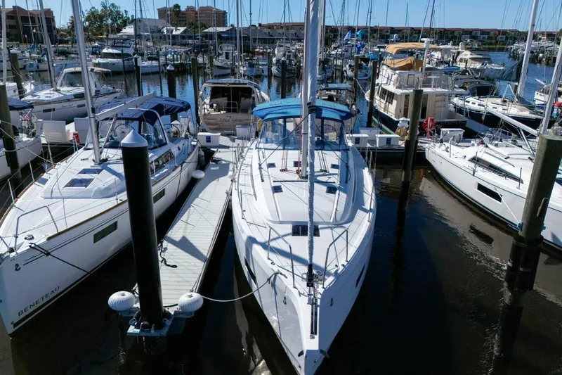 Slide: The Image of 2022 Beneteau Oceanis 40.1 yacht docked in a marina, surrounded by other boats. - 112