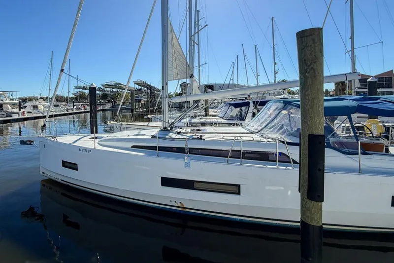 Slide: The Image of 2022 Beneteau Oceanis 40.1 sailboat docked in a marina under clear blue skies. - 116