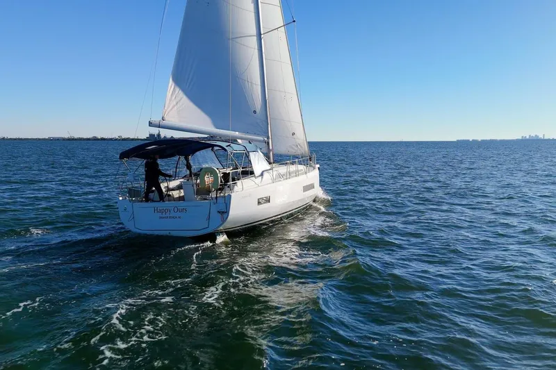 Slide: The Image of 2022 Beneteau Oceanis 40.1 sailing on open water under clear blue sky. - 128
