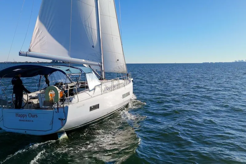 Slide: The Image of 2022 Beneteau Oceanis 40.1 sailboat cruising on open water under clear blue skies. - 130