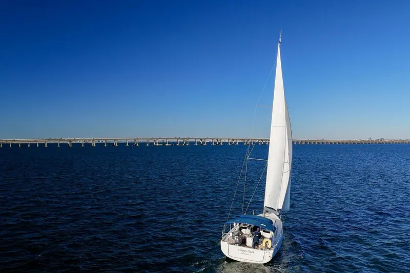 Slide: The Image of 2022 Beneteau Oceanis 40.1 sailing on open water under clear blue sky. - 140