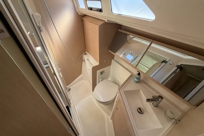Slide: The Image of 2022 Beneteau Oceanis 40.1 yacht bathroom with modern fixtures and natural lighting. - 15