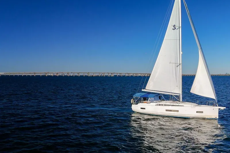 Slide: The Image of 2022 Beneteau Oceanis 40.1 sailing on open water under clear blue sky. - 151