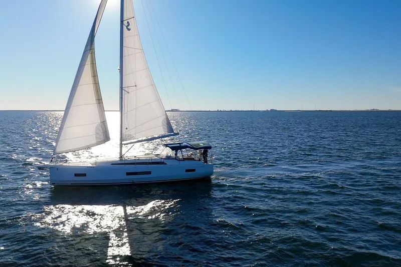 Slide: The Image of 2022 Beneteau Oceanis 40.1 sailing on open water under clear blue sky. - 156