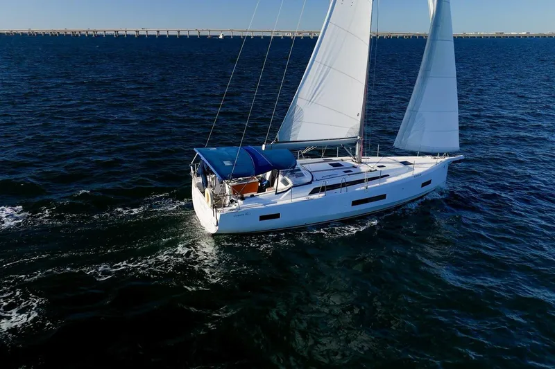Slide: The Image of 2022 Beneteau Oceanis 40.1 sailing on open water with bridge in background. - 162