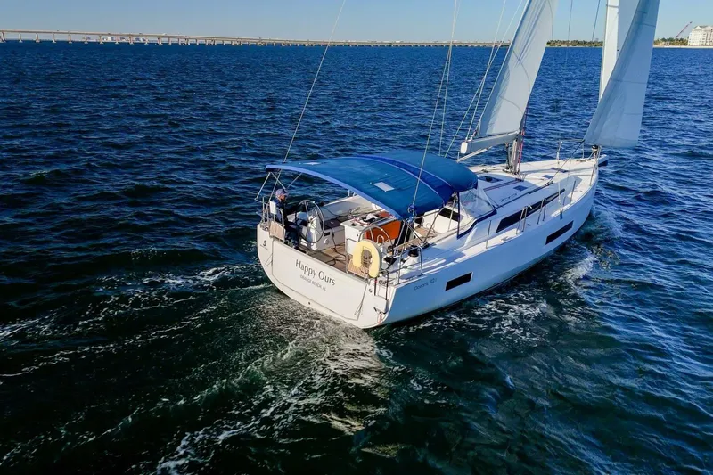 Slide: The Image of 2022 Beneteau Oceanis 40.1 sailing on open water, blue canopy, clear sky. - 165