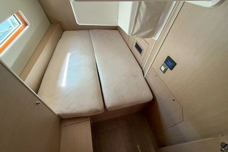 Slide: The Image of Interior cabin of 2022 Beneteau Oceanis 40.1 yacht, featuring a cozy bed and modern design. - 18