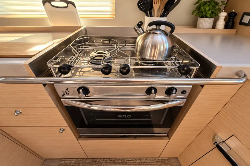 Slide: The Image of Modern kitchen in 2022 Beneteau Oceanis 40.1 yacht with stove and kettle. - 15