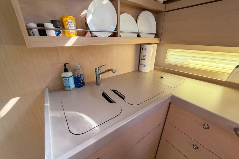 Slide: The Image of Modern kitchen in 2022 Beneteau Oceanis 40.1 yacht with sink and storage. - 27