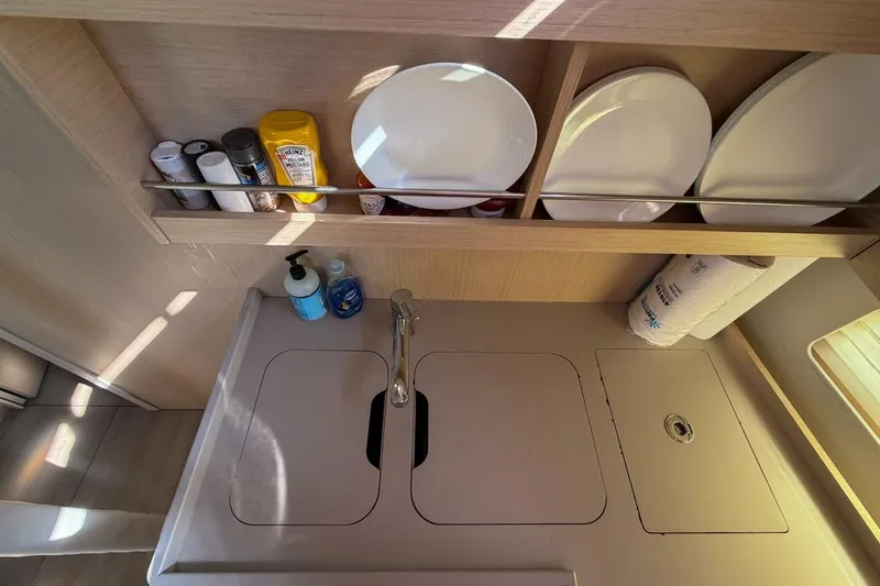 Slide: The Image of Modern kitchen area in 2022 Beneteau Oceanis 40.1 yacht with sink and storage. - 28