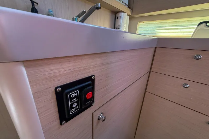 Slide: The Image of Interior of 2022 Beneteau Oceanis 40.1 yacht kitchen with gas control switch. - 29