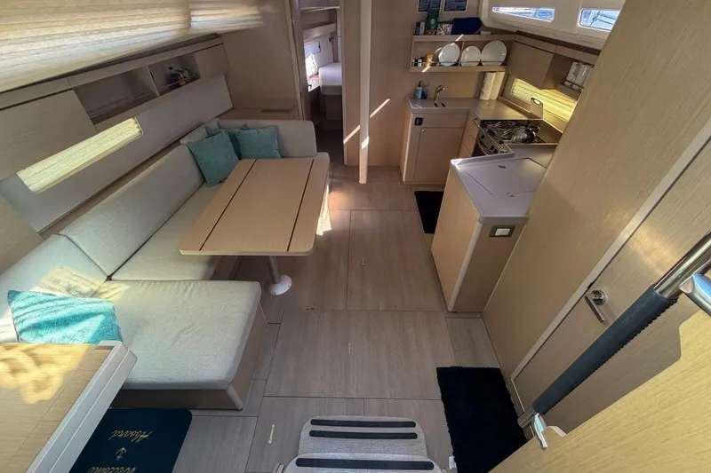 Slide: The Image of Interior of 2022 Beneteau Oceanis 40.1 yacht, featuring modern kitchen and cozy seating area. - 3