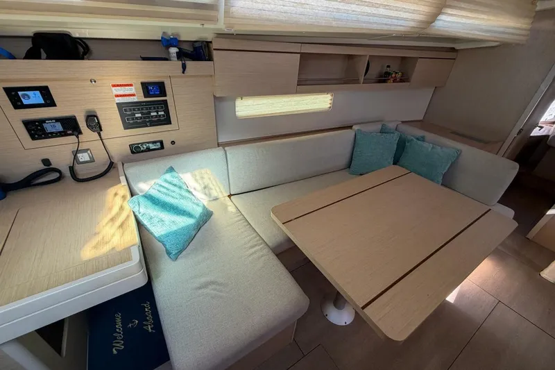 Slide: The Image of Interior of 2022 Beneteau Oceanis 40.1 yacht with cozy seating and navigation panel. - 34