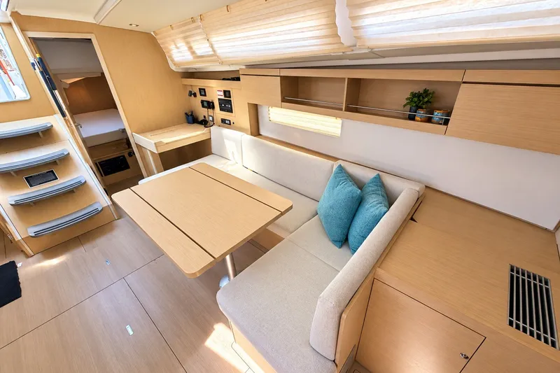 Slide: The Image of Modern interior of 2022 Beneteau Oceanis 40.1 yacht with cozy seating and wooden finishes. - 9