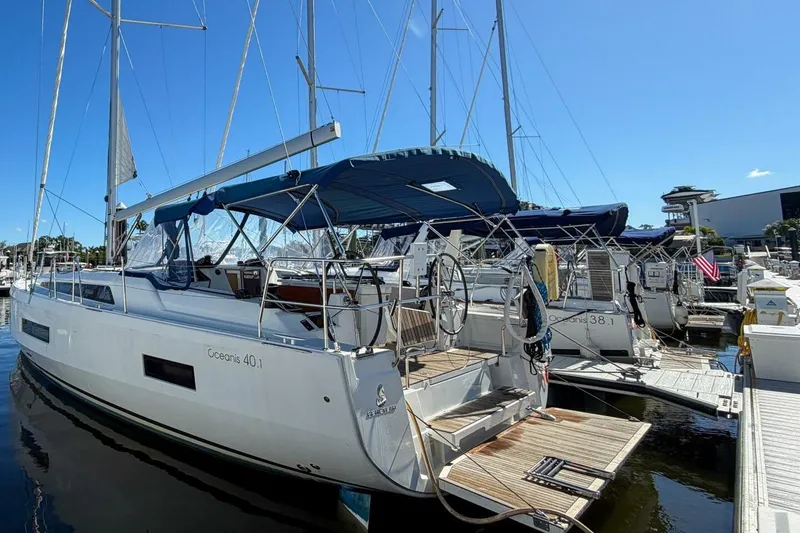 Slide: The Image of 2022 Beneteau Oceanis 40.1 sailboat docked at marina under clear blue sky. - 46