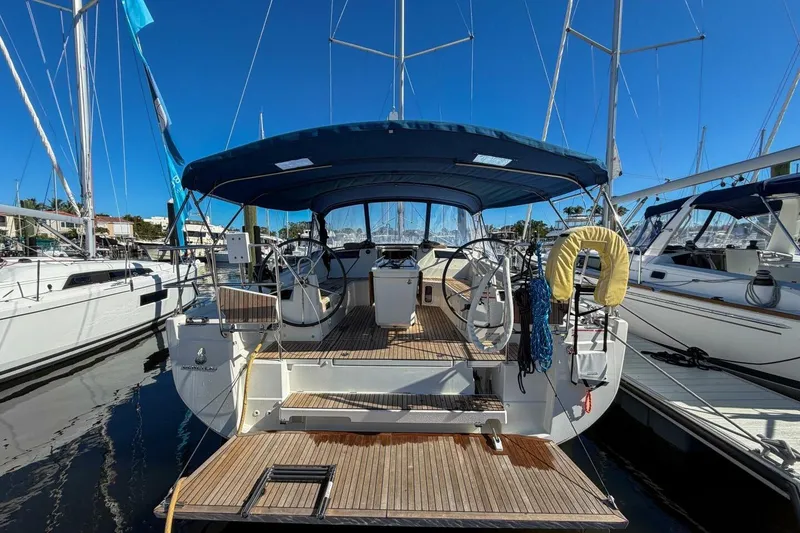 Slide: The Image of 2022 Beneteau Oceanis 40.1 sailboat docked, featuring dual steering wheels and spacious deck. - 48