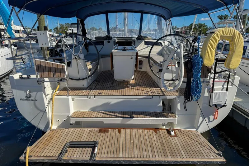 Slide: The Image of 2022 Beneteau Oceanis 40.1 yacht with dual steering wheels and teak deck in marina. - 49