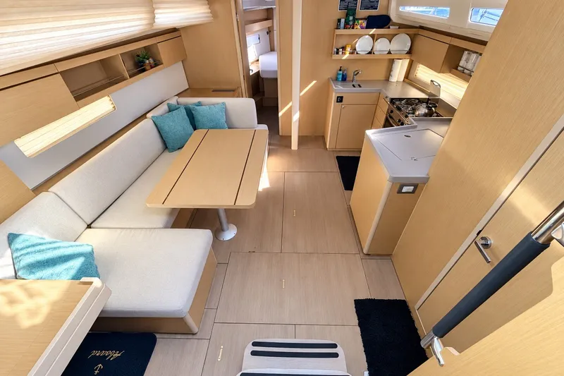 Slide: The Image of Modern interior of 2022 Beneteau Oceanis 40.1 yacht with cozy seating and kitchen area. - 3