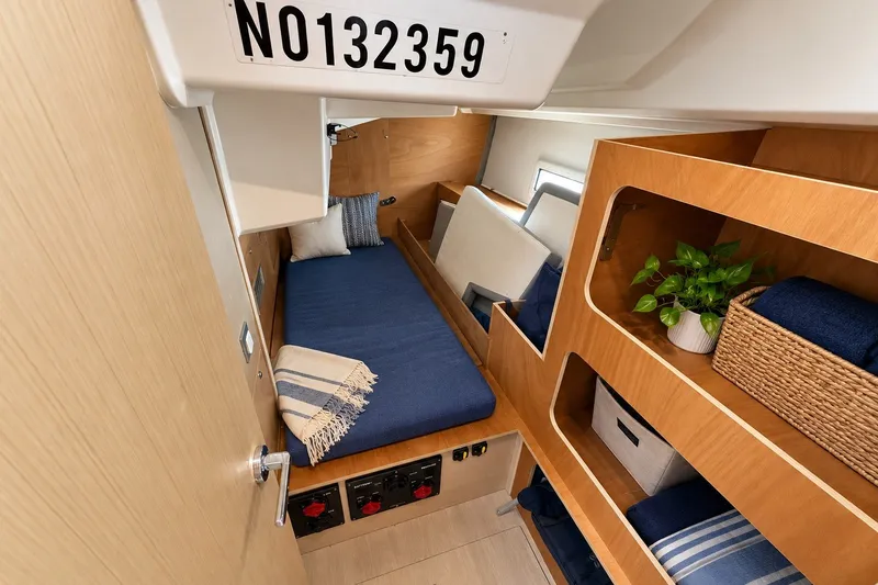 Slide: The Image of Interior of 2022 Beneteau Oceanis 40.1 yacht cabin with cozy bed and storage shelves. - 161