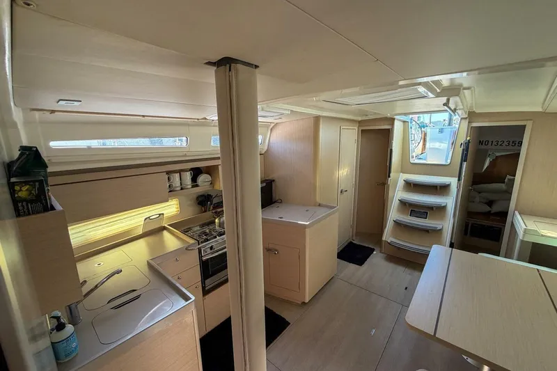 Slide: The Image of Interior of 2022 Beneteau Oceanis 40.1 yacht, featuring modern kitchen and cozy living space. - 5