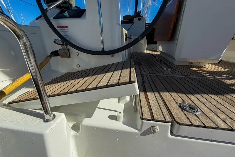 Slide: The Image of Beneteau Oceanis 40.1 cockpit with teak flooring, 2022 model, showcasing steering wheel and deck details. - 52