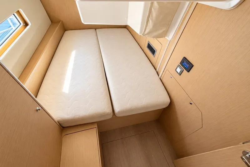 Slide: The Image of Interior cabin of 2022 Beneteau Oceanis 40.1 yacht with twin beds and wooden finish. - 30