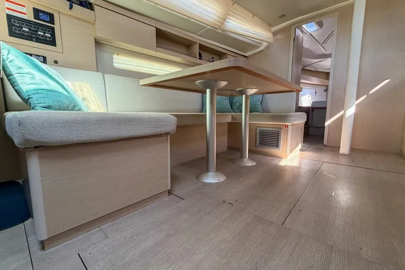 Slide: The Image of Interior of 2022 Beneteau Oceanis 40.1 yacht with modern seating and dining area. - 7