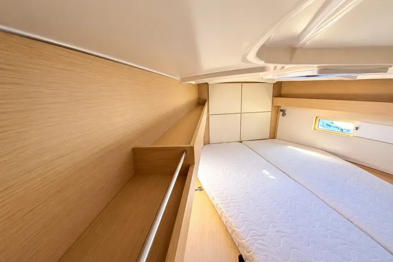 Slide: The Image of Interior cabin of 2022 Beneteau Oceanis 40.1 yacht with wooden finish and cozy bed. - 20