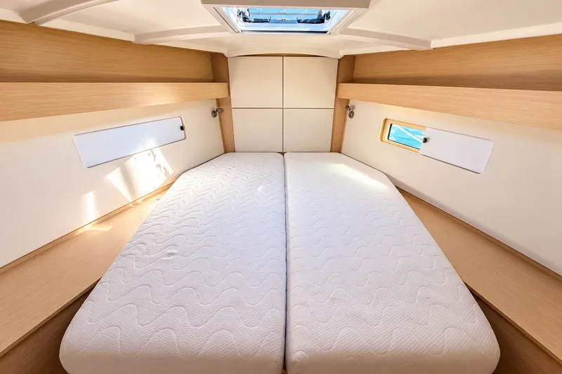 Slide: The Image of Interior cabin of 2022 Beneteau Oceanis 40.1 yacht, featuring a comfortable double bed. - 21