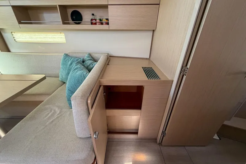 Slide: The Image of Interior of 2022 Beneteau Oceanis 40.1 yacht, featuring cozy seating and storage. - 8