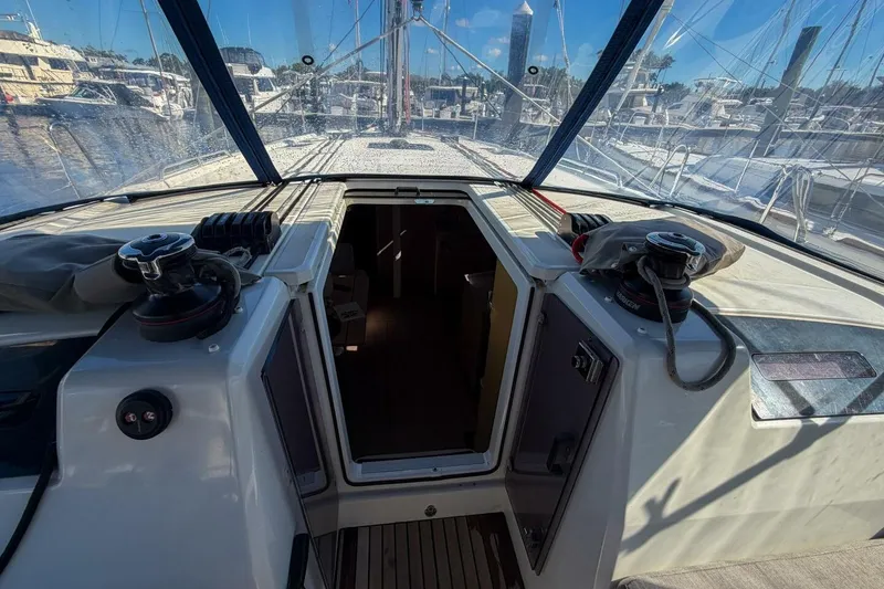 Slide: The Image of Cockpit view of 2022 Beneteau Oceanis 40.1 sailboat, featuring winches and marina background. - 83