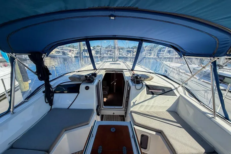 Slide: The Image of 2022 Beneteau Oceanis 40.1 yacht cockpit with blue canopy and marina view. - 84
