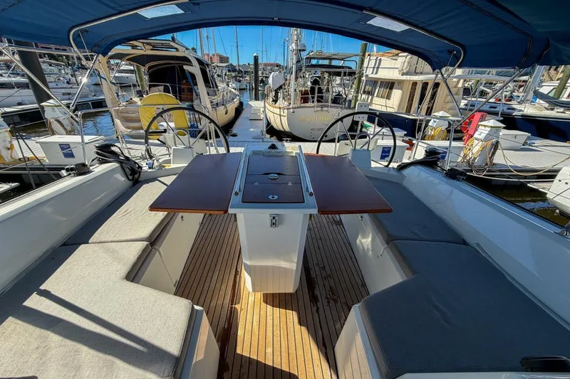 Slide: The Image of 2022 Beneteau Oceanis 40.1 yacht interior with seating and table in a marina. - 88