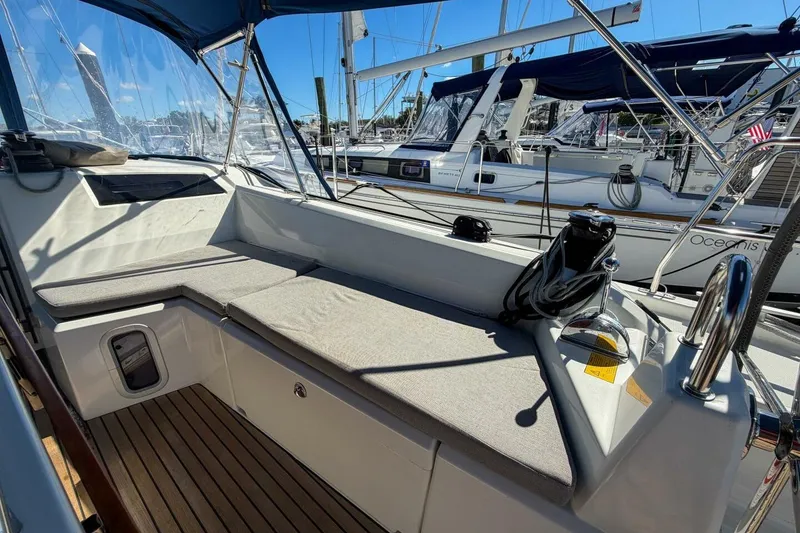 Slide: The Image of 2022 Beneteau Oceanis 40.1 yacht cockpit with cushioned seating and winch, docked at marina. - 90