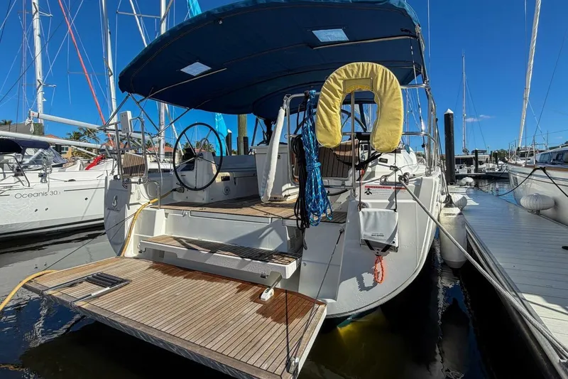 Slide: The Image of 2022 Beneteau Oceanis 40.1 yacht docked at marina, rear view with open deck. - 91