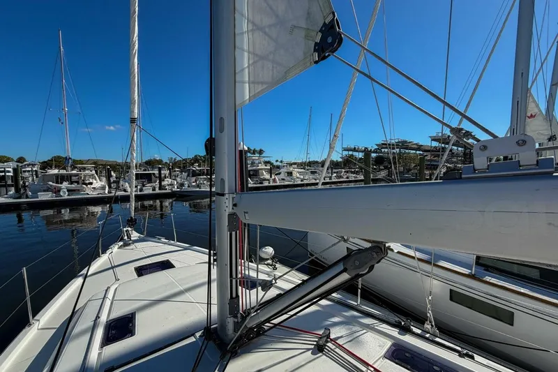 Slide: The Image of 2022 Beneteau Oceanis 40.1 sailboat docked at a marina under clear blue skies. - 95