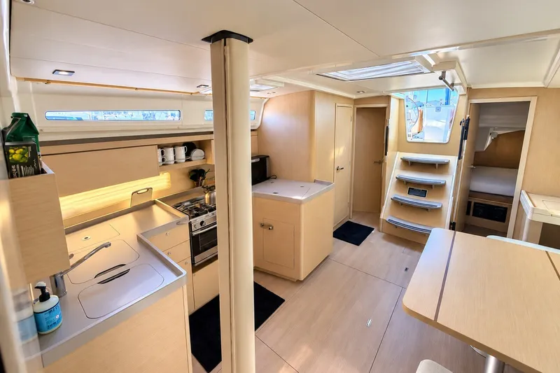 Slide: The Image of Modern interior of 2022 Beneteau Oceanis 40.1 yacht, featuring a sleek kitchen and cozy cabin. - 11