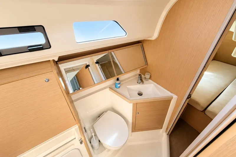 Slide: The Image of Modern bathroom interior of 2022 Beneteau Oceanis 40.1 yacht, featuring sleek wood finishes. - 26
