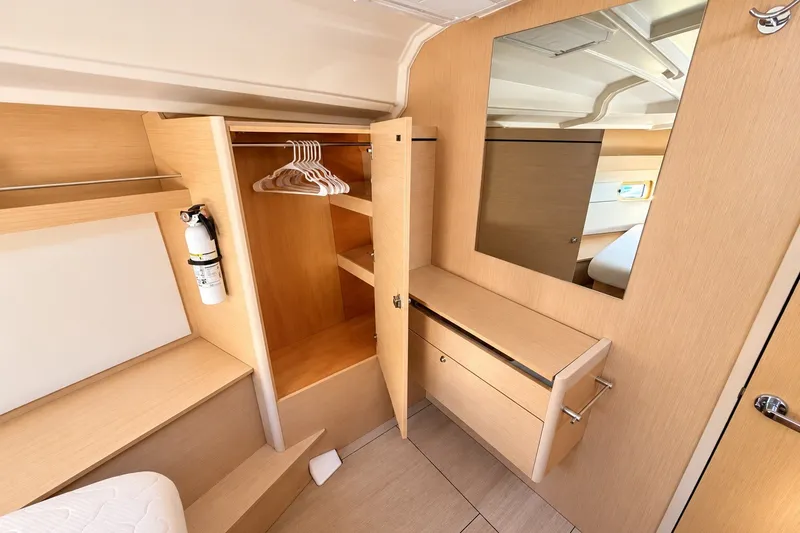 Slide: The Image of Interior of 2022 Beneteau Oceanis 40.1 yacht with wooden cabinetry and mirror. - 23
