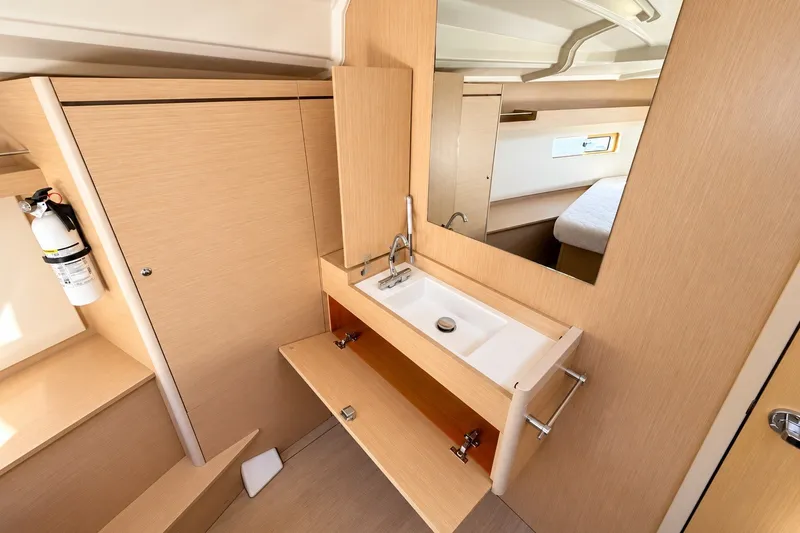 Slide: The Image of Interior of 2022 Beneteau Oceanis 40.1 yacht bathroom with modern sink and mirror. - 24