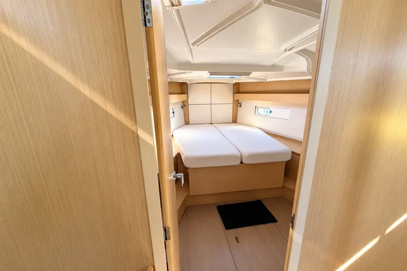 Slide: The Image of Interior cabin of 2022 Beneteau Oceanis 40.1 yacht, featuring a cozy double bed. - 19