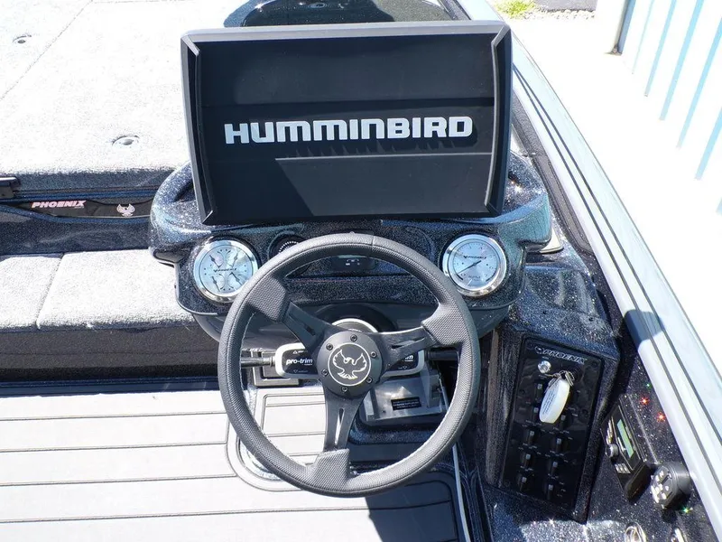 Slide: The Image of 2025 Phoenix 920 Elite boat dashboard with Humminbird display and steering wheel. - 10