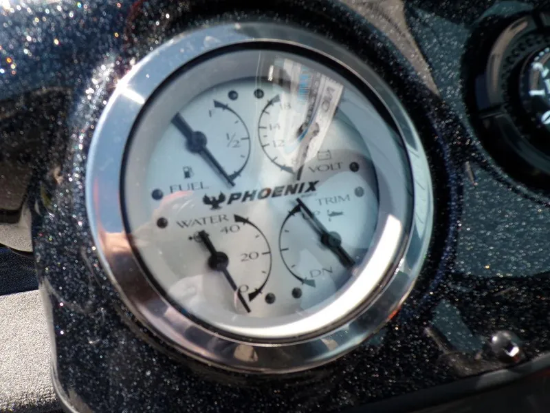 Slide: The Image of Dashboard gauges of 2025 Phoenix 920 Elite boat, showing fuel, volt, water, and trim levels. - 12