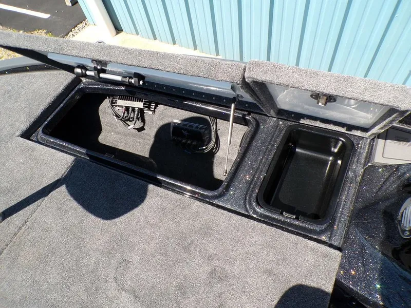 Slide: The Image of Open storage compartments in a 2025 Phoenix 920 Elite boat, showcasing interior space and wiring. - 20