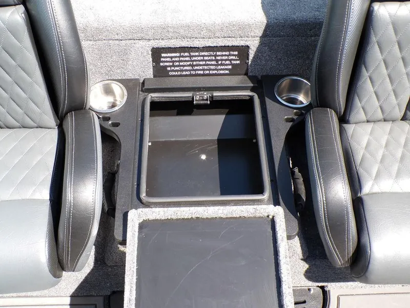 Slide: The Image of 2025 Phoenix 920 Elite boat interior with storage compartment and cup holders. - 24