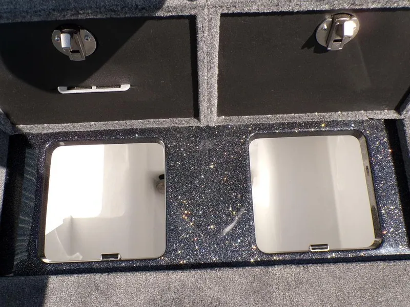 Slide: The Image of Two open storage compartments in a 2025 Phoenix 920 Elite boat. - 26